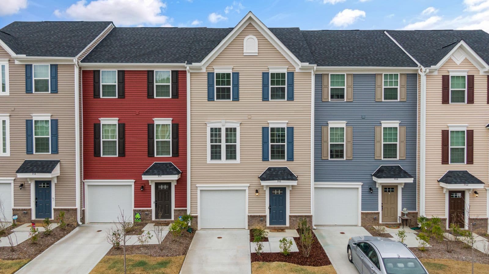 Townhouses with red, tan and blue siding