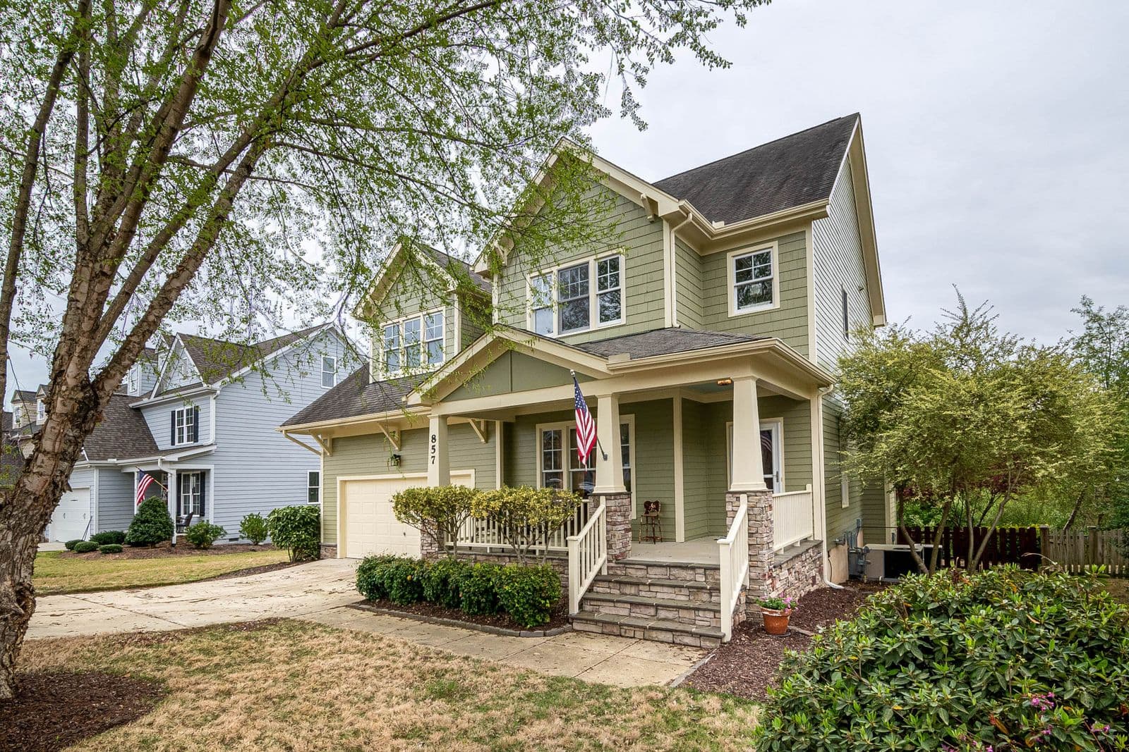 Two-story house with green siding and a front porch